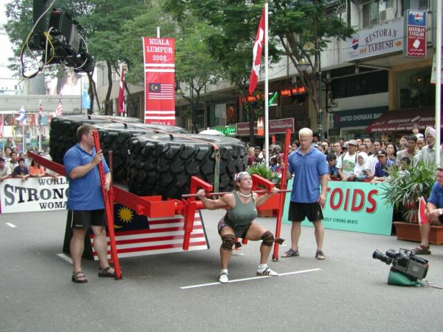 Jill Mills squatting in competition in Maylasia. Photo by Monica Brant.